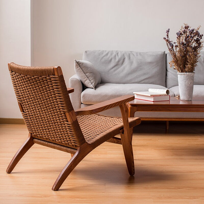 A chic and stylish lounge chair made of rattan with a natural wood or walnut finish that will complement any decor.